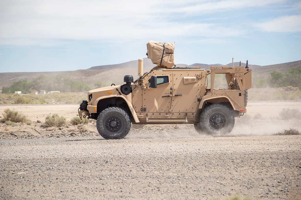 A military vehicle equipped for survivability testing in an open landscape